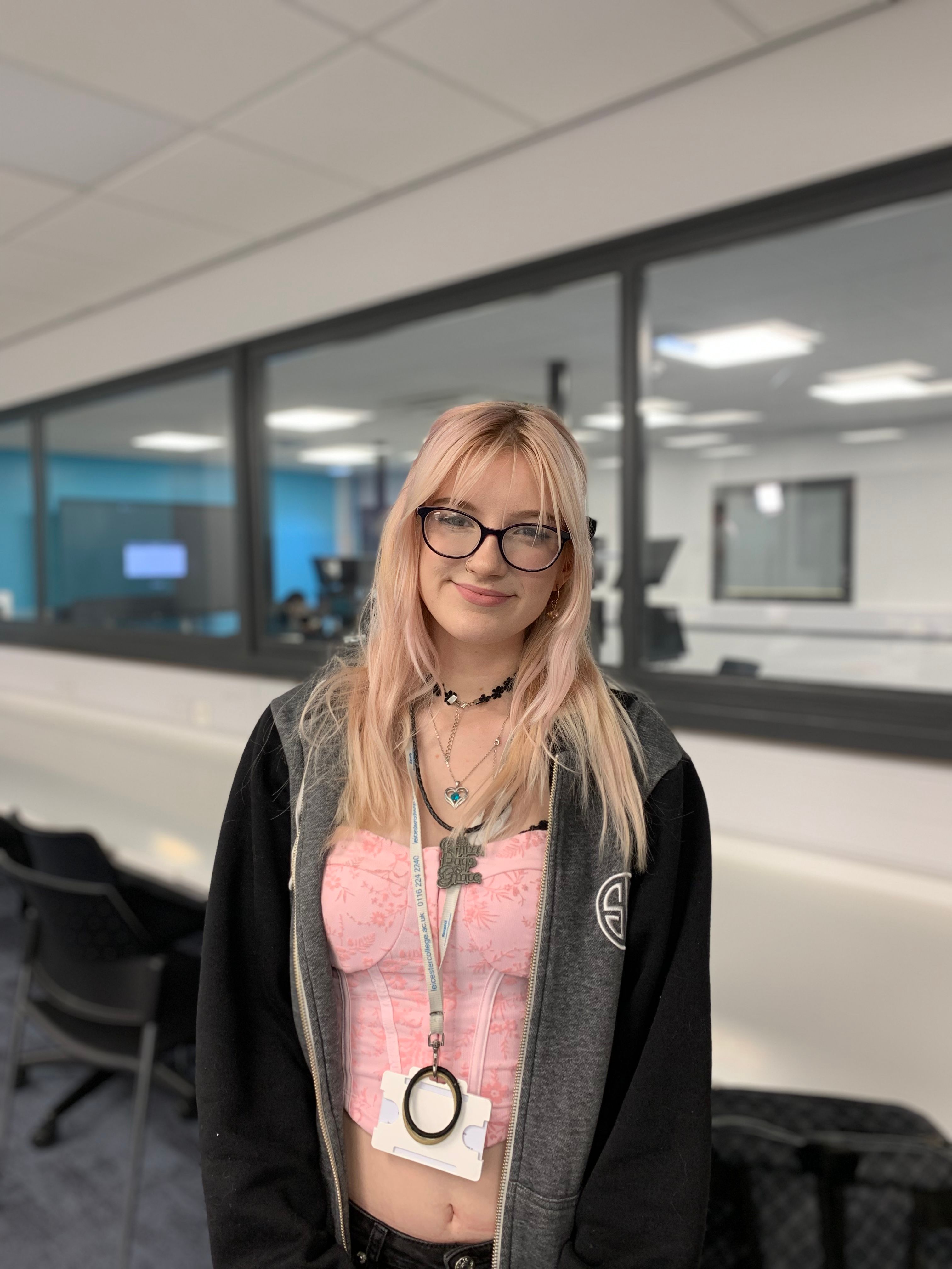 Lily standing in a computing classroom