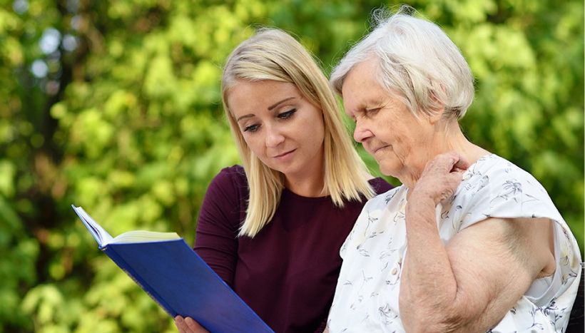 young-girl-with-an-elderly-lady-looking-at-a-folder