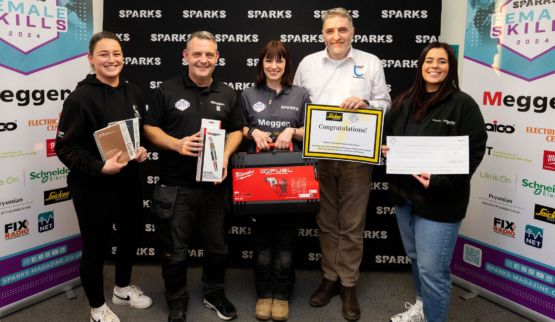 group photo of three white women and two white men with awards and prizes