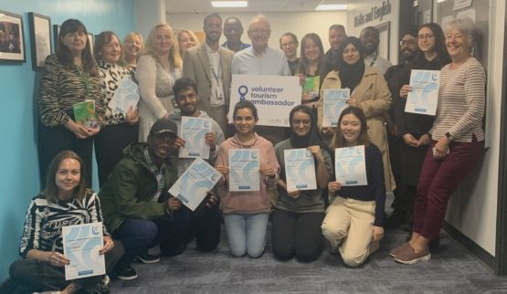 Group of Leicester College students and staff show certificates for achieving volunteer tourism ambassador status