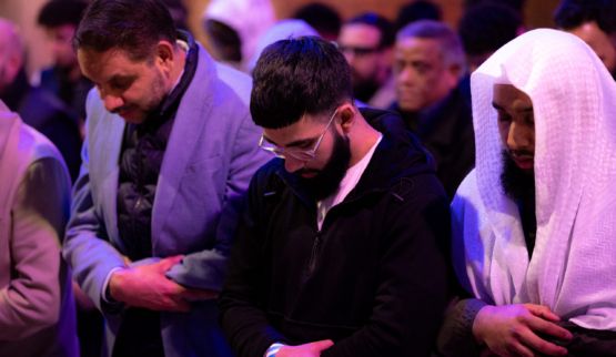 Asian males praying together