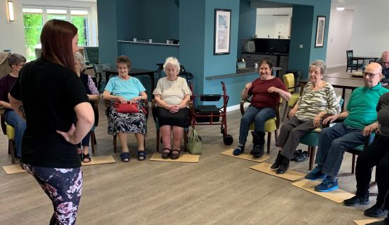 Student at Oak Court care home presenting to a group of elderly residents.