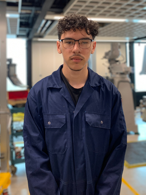 Engineering student in blue overalls